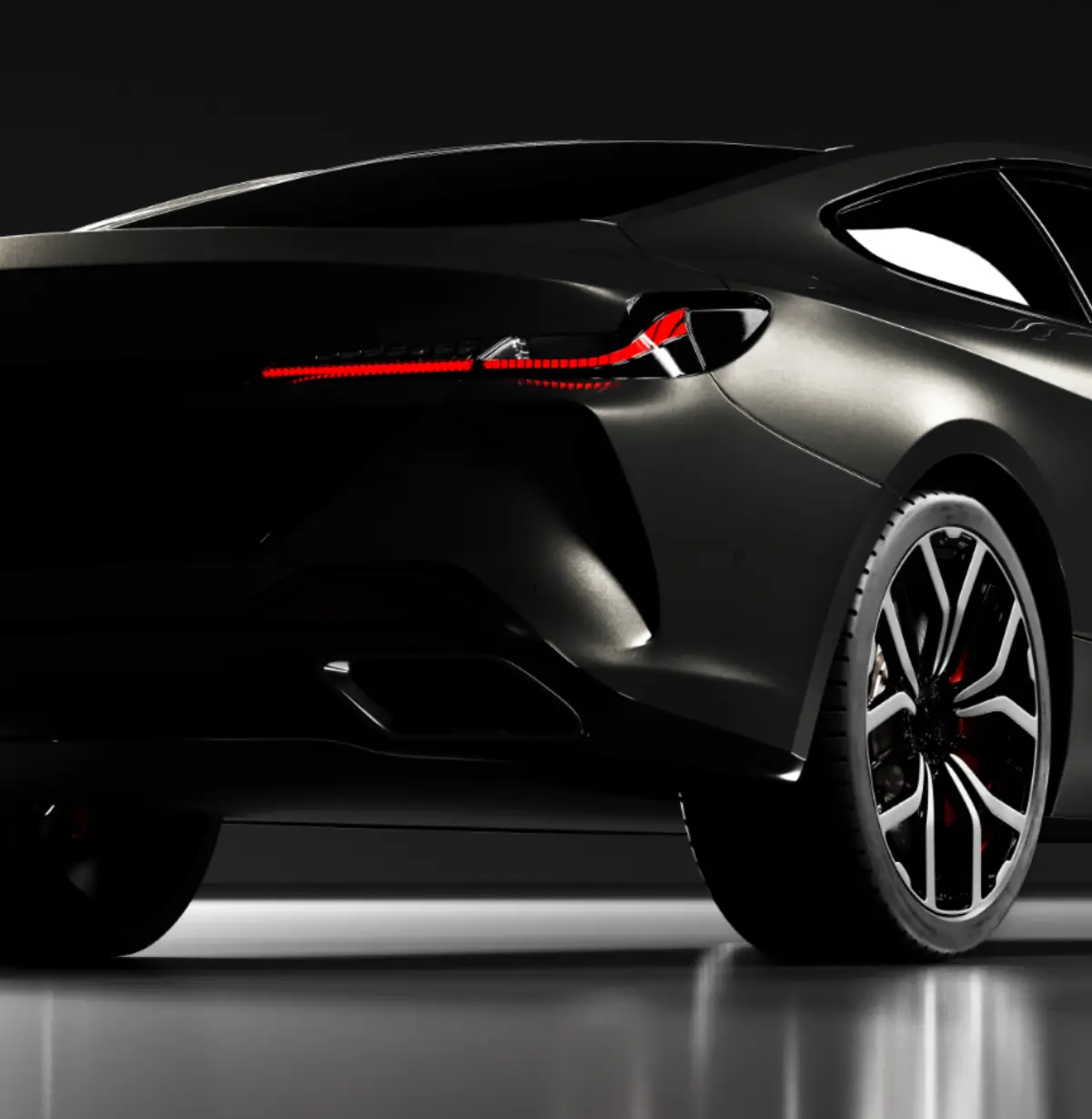 A sleek, modern black sports car is shown from the rear three-quarter angle, highlighting its sharp taillights, stylish alloy wheels, and aerodynamic lines against a dark background.